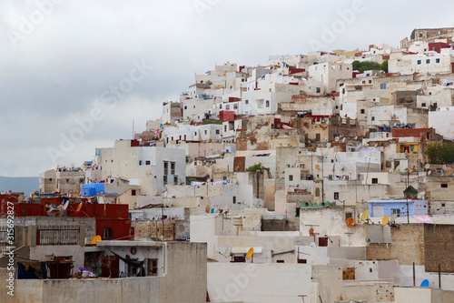 View of the colorful old buildings of Tetouan Medina quarter in Northern Morocco. A medina is typically walled, with many narrow and maze-like streets and often contain historical houses and places. © Renar