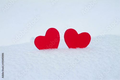 Two red felt hearts on the snow. Handmade for the celebration and holiday. Stock Photography for Valentine s Day with empty space for your text. For web  print  cards  invitations and wallpapers.