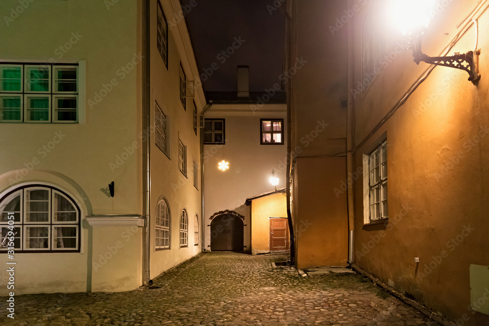 Night view of the old courtyard in the historical part of Tallinn. The city is the capital and the most populous city of Estonia.