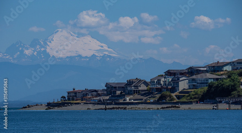 Pacific NW Puget Sound Touring Scenes:  Mount Baker background with Camano Island beachfront houses in foreground © Dawn