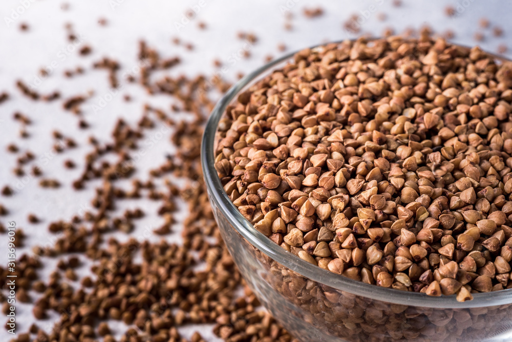 healthy buckwheat in a bowl isolated on gray background close-up with place for text healthy buckwheat in a bowl isolated on gray background close-up with place for text