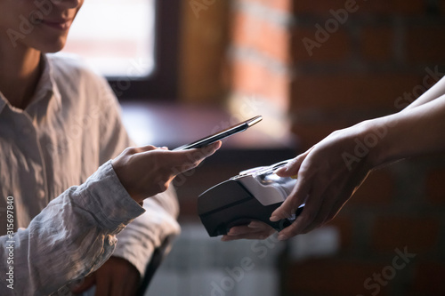 Cafe customer make payment with cellphone nfc technology