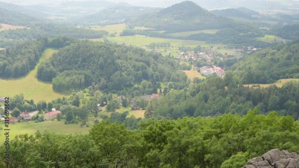 A view of a valley of towns and villages, set in nature with hills and mountains. A view of a valley of towns and villages, set in nature with hills and mountains.