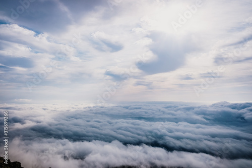 Awesome view on top of the clouds on a cloudy morning.
