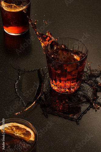 Ice Cube Splashing into a Negroni Cocktail