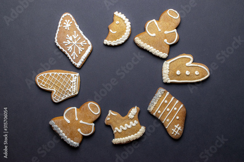 Cookies background. Christmas homemade gingerbread cookies on dark. Celebration cooking Winter concept. New year and christmas postcard or invitation