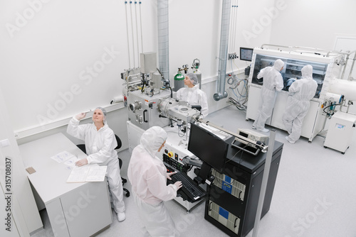 Team of scientists working in laboratory of technology center photo