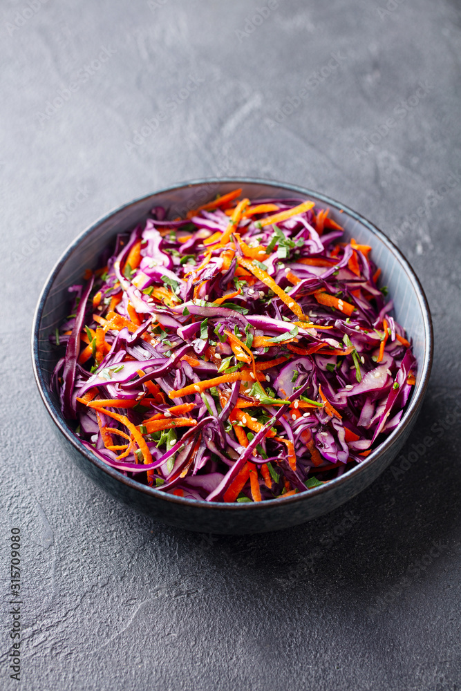 Red cabbage salad, Coleslaw in a bowl. Grey background.