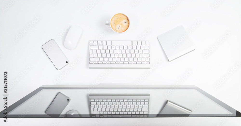 Top view of the office table, keyboard, monitor, coffee, mouse, telephone. The concept of office work, work in front of a computer. Preparation for duties. Top view of the office table, keyboard, monitor, coffee, mouse, telephone. The concept of office work, work in front of a computer. Preparation for duties.