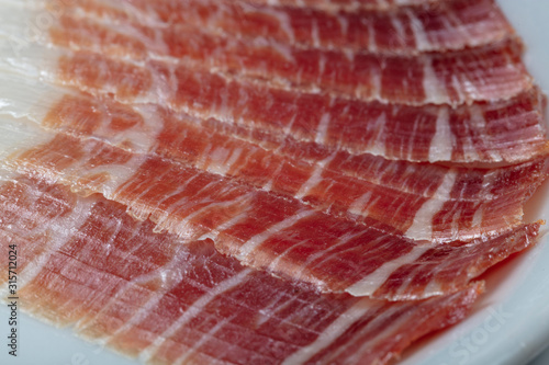 Plato de jamón ibérico cortado sobre plato. Plate of Iberian ham sliced ​​on a plate. photo