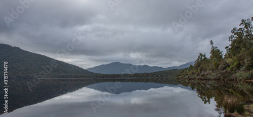 Westcoast South Island New Zealand. Reflection of Mountain in lake.  photo