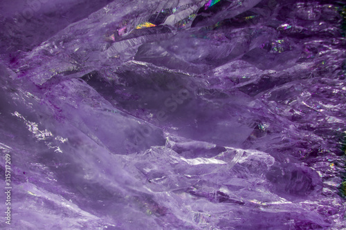 A close up macro photograph of a cut and polished purple agate crystal stone geode texture