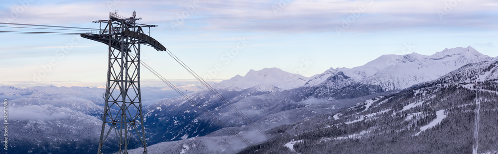 Whistler, British Columbia, Canada. Beautiful Panoramic View of Peak to Peak Gondola with the Canadian Snow Covered Mountain Landscape during a cloudy and vibrant winter sunset Whistler, British Columbia, Canada. Beautiful Panoramic View of Peak to Peak Gondola with the Canadian Snow Covered Mountain Landscape during a cloudy and vibrant winter sunset