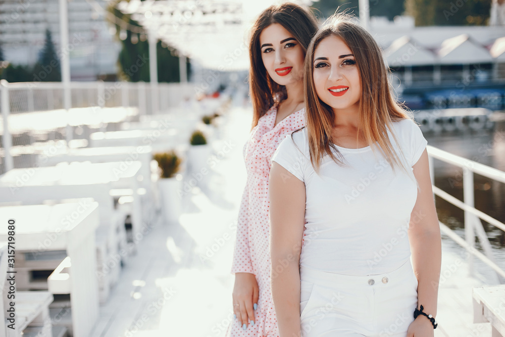 Beautiful girls celebration. Friends have fun in a summer park Beautiful girls celebration. Friends have fun in a summer park