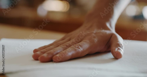 Wallpaper Mural Macro of an artisan paper making master is touching a sheet of handmade paper to control a quality in a workshop. Concept of handmade,high quality,artisan, made in Italy,tradition Torontodigital.ca
