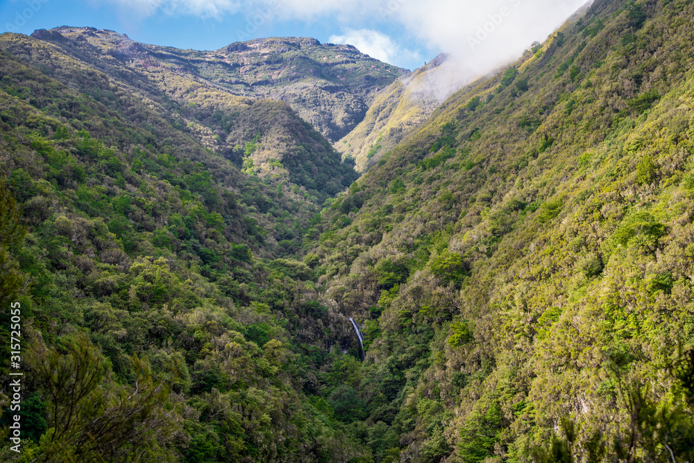 Caldeirao Verde waterfall with mountain landscape on the Levada Caldeirao Verde near Santana on the island of Madeira, Portugal.