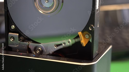 Boot read head on computer hard drive. Computer hard drive, open, read / write head and hard drive.