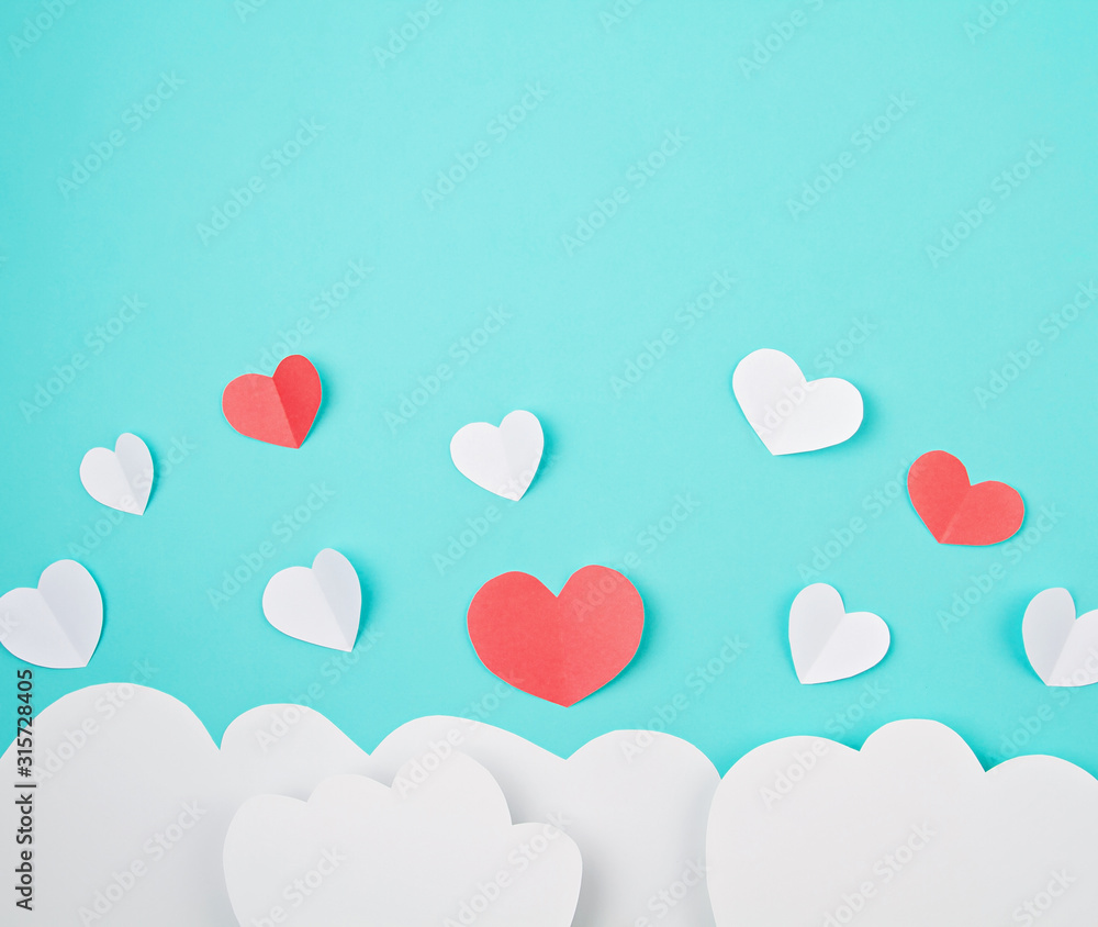White paper hearts and clouds over the tuquiose background. Sainte Valentine, mother's day, birthday greeting cards, invitation, celebration concept