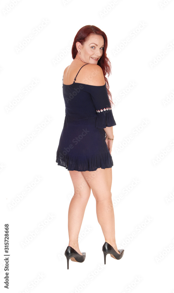 Gorgeous woman standing from the back in a black dress Gorgeous woman standing from the back in a black dress
