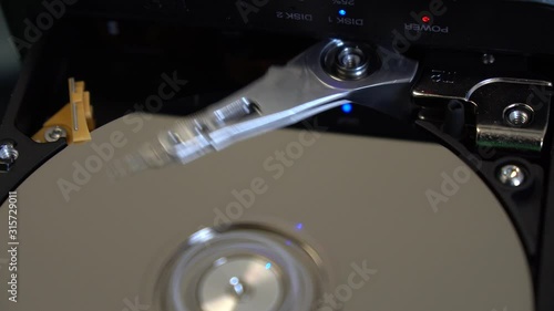 Boot read head on computer hard drive. Computer hard drive, open, read / write head and hard drive.