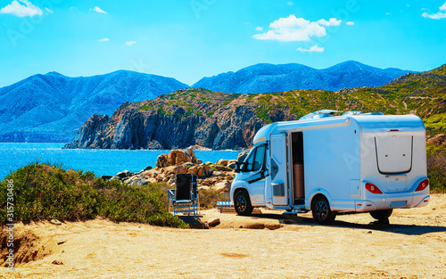 Camper on road at Capo Pecora at Mediterranean sea in Sardinia Island, Italy summer Fototapet