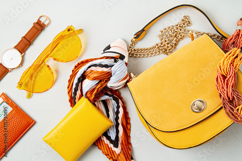 Flat lay with woman fashion accessories in yellow colors. Fashion blog, summer style, shopping and trends idea photo
