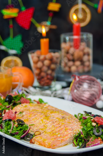 Oven baked salmon with grapefruit salad. Red Fish Steak served with salad and olive oil on plate.