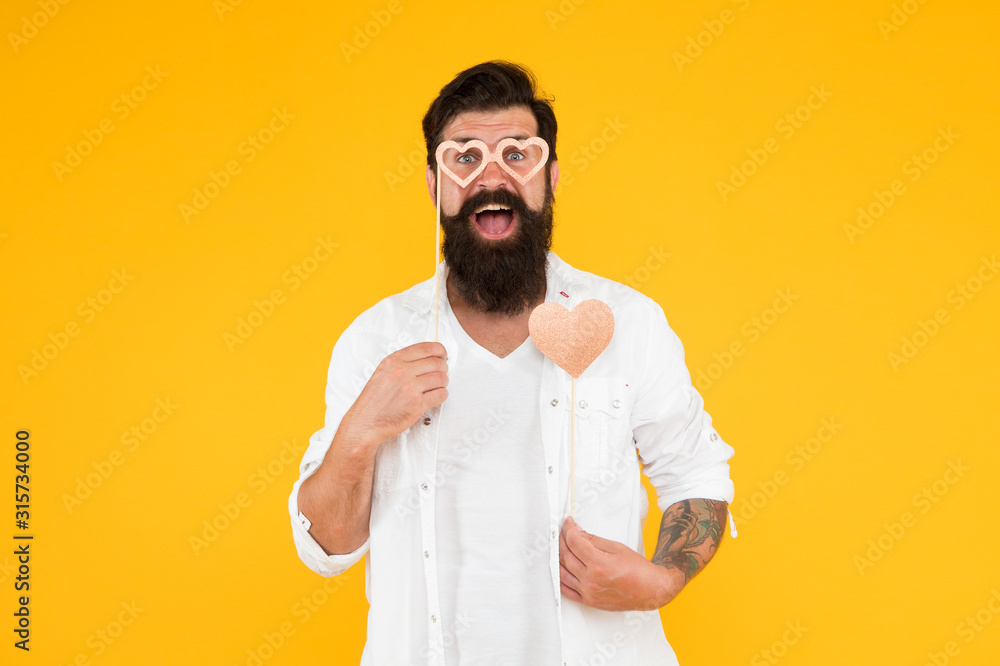 Start this party. Expressing love. Health care concept. Hipster with small heart. Positive vibes. Romantic mood. Happy valentines day. Bearded man holding heart. Valentine man with heart shaped card Start this party. Expressing love. Health care concept. Hipster with small heart. Positive vibes. Romantic mood. Happy valentines day. Bearded man holding heart. Valentine man with heart shaped card