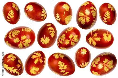 Collection of Easter eggs dyed with onion husks with fresh leaf imprints isolated on white background. Creative decoration. Folk Easter traditions. Closeup © Володимир Захаров