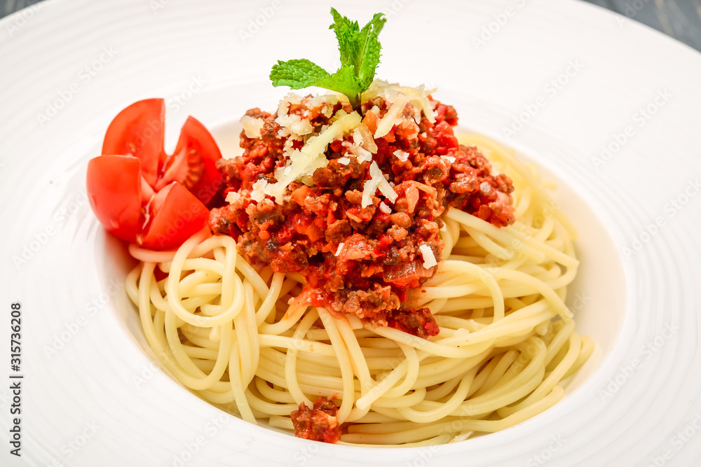spaghetti dinner with meat sauce and basil close up spaghetti dinner with meat sauce and basil close up
