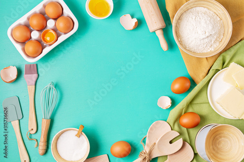 Rustic baking ingredients and kitchen utensils. Homemade pastry, baking. Top view flat lay background. Copy space. Healthy fresh organic food.