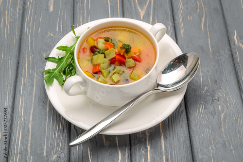 chicken soup with vegetables. On a wooden table