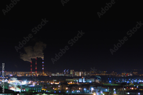Night city skyline. Top aerial panoramic view of modern city from tower rooftop. Road junction traffic