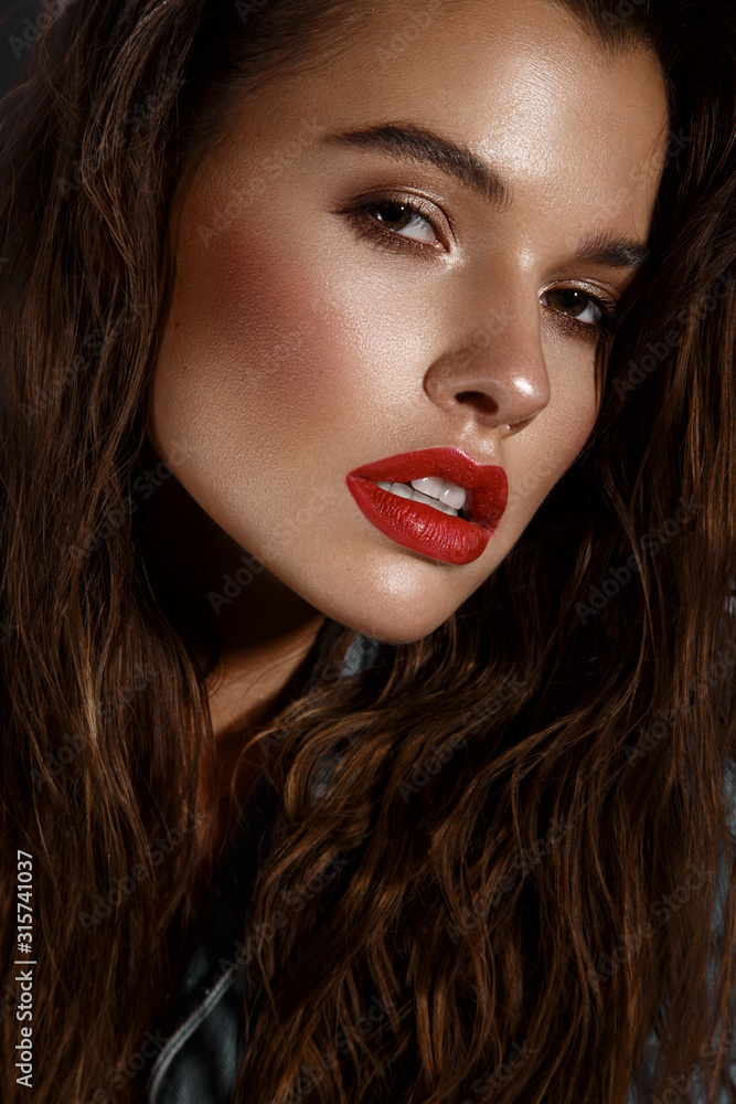 Fototapeta premium Beautiful sexy girl with bright makeup, red lips, wet hair. Beauty face.