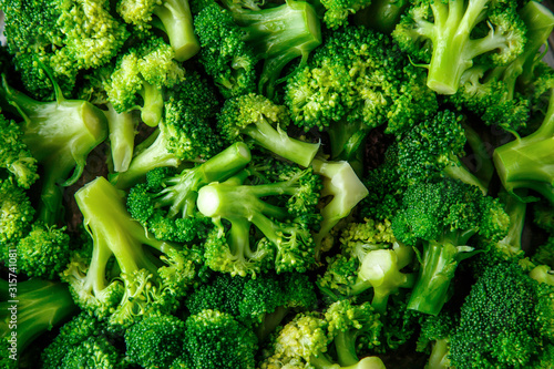 Macro photo green fresh vegetable broccoli. Fresh green broccoli on a black stone table.Broccoli vegetable is full of vitamin.Vegetables for diet and healthy eating.Organic food. photo