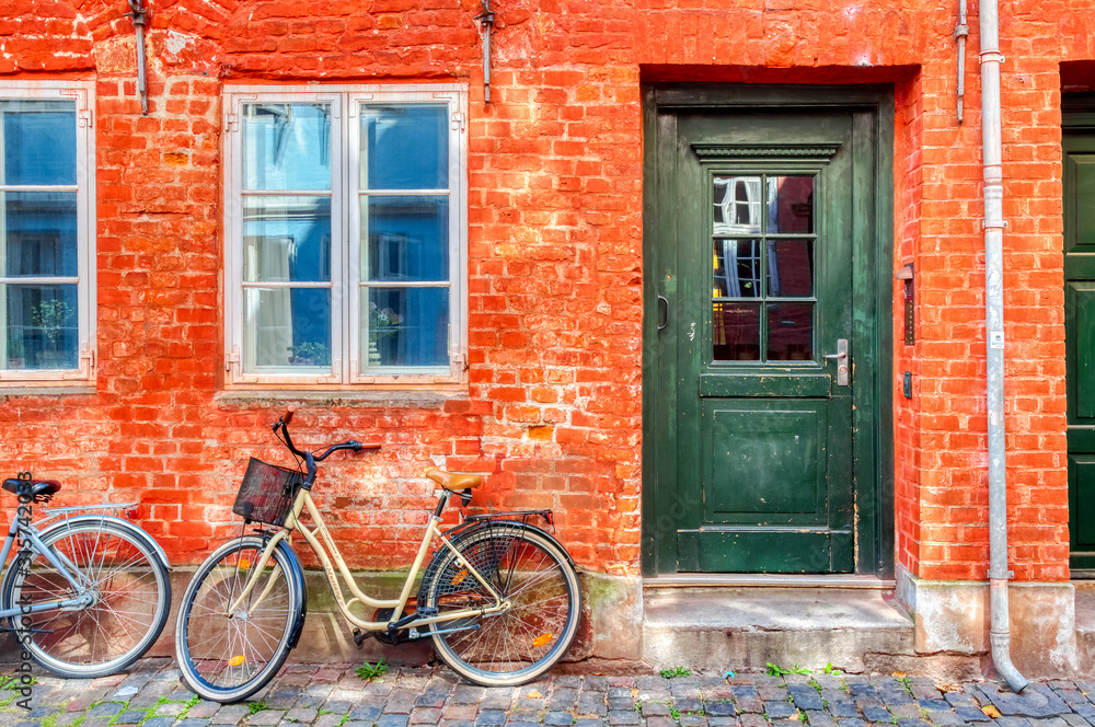 Old red house in the center of Copenhagen with bicycle. Old Medieval district in Copenhagen, Denmark