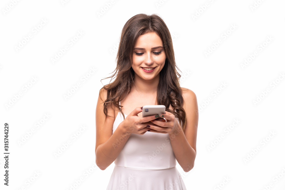 Young woman sending a sms on cell phone on white background Young woman sending a sms on cell phone on white background