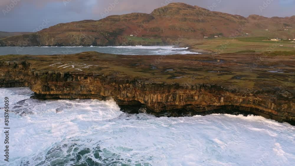 Huge waves breaking at Muckross Head - A small peninsula west of Killybegs, County Donegal, Ireland. The cliff rocks are famous for climbing Huge waves breaking at Muckross Head - A small peninsula west of Killybegs, County Donegal, Ireland. The cliff rocks are famous for climbing
