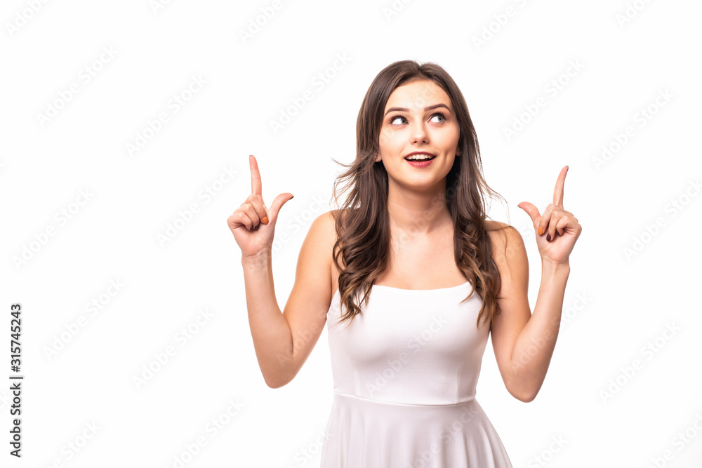 Happy young woman pointing up with both hands isolated on a white background Happy young woman pointing up with both hands isolated on a white background