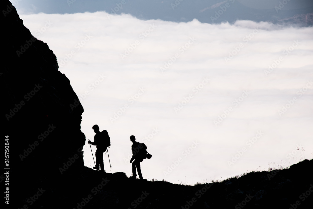 Hikers above the clouds