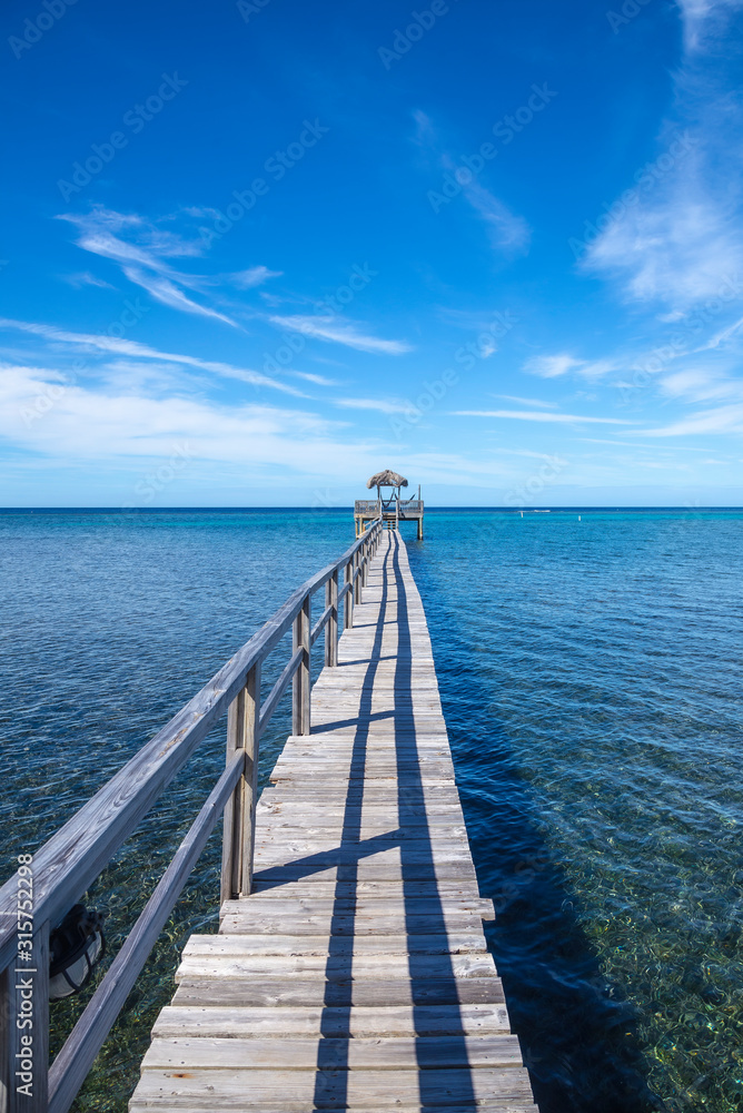 Wooden footbridge over the Caribbean Sea on Roatan Island. Honduras