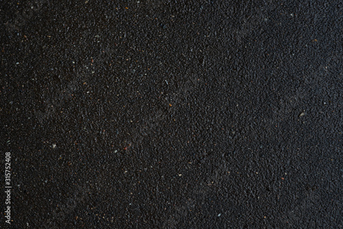 Asphalt, texture asphalt at the road under construction. Asphalt background, asphalt on concrete texture. Wet asphalt.