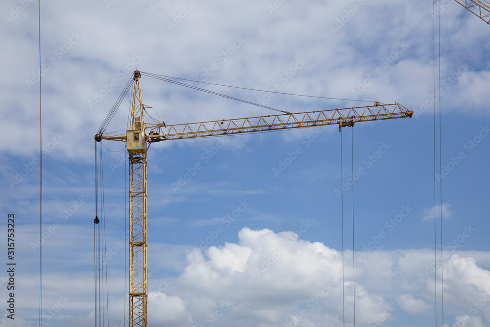Tower Crane in the clouds and blue sky. Tower Crane in the clouds and blue sky.