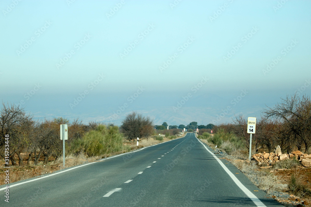 road to the horizon in the Gorafe badlands in Spain and blue sky