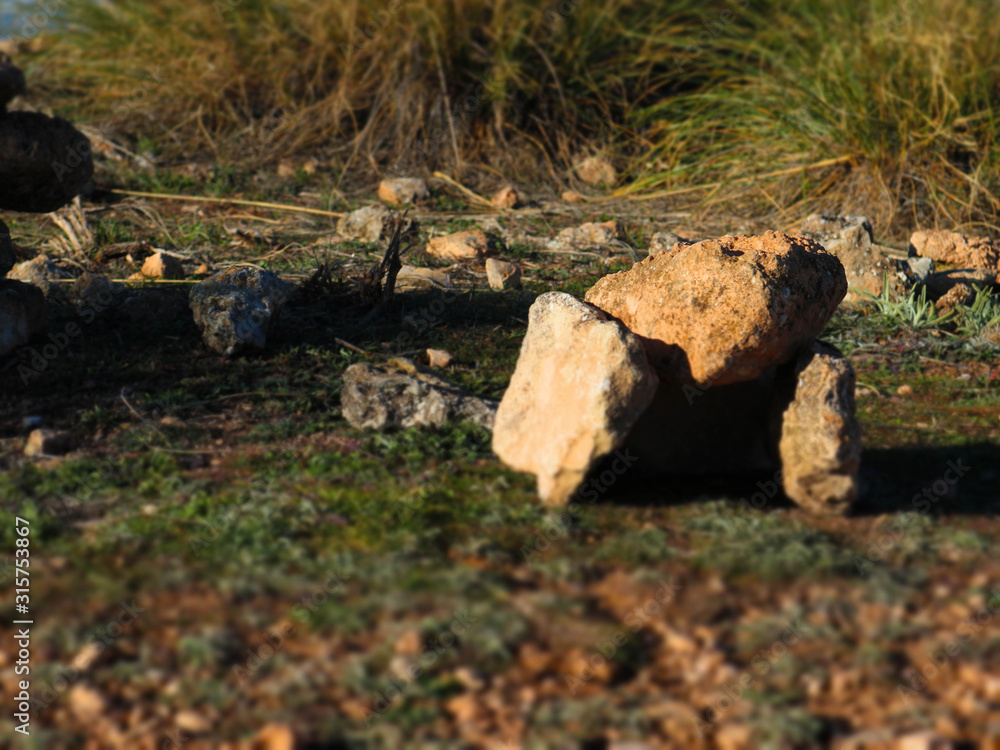 small dolmen made by child on the stone with badlands on the background