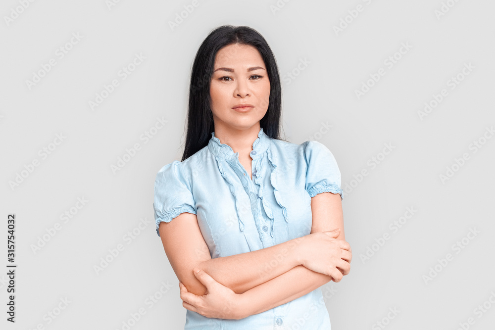 Freestyle. Asian woman standing isolated on white crossed arms pensive Freestyle. Asian woman standing isolated on white crossed arms pensive