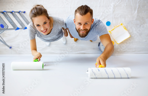 young happy family married couple dreams of renovating  house and planning  design project.