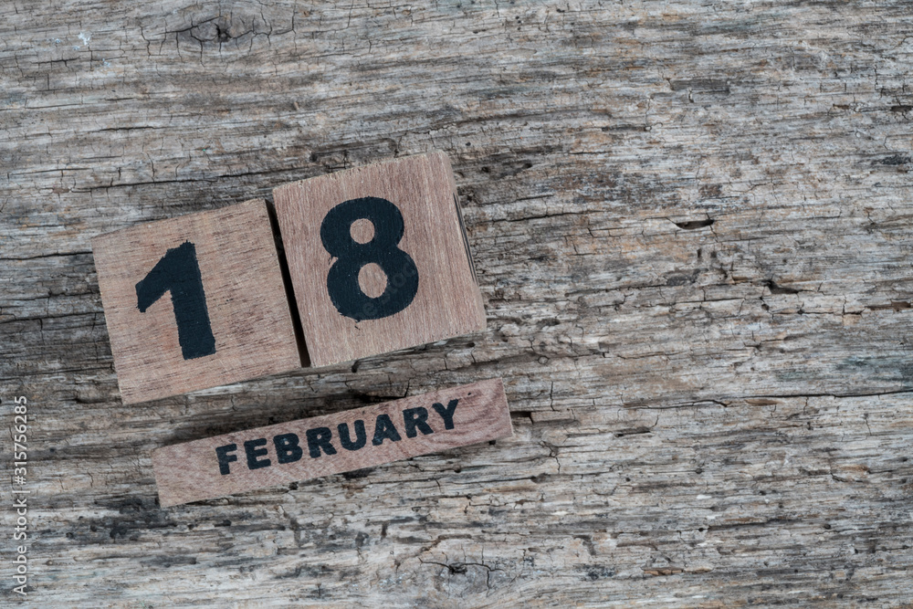 cube calendar for february on wooden background with copy space cube calendar for february on wooden background with copy space