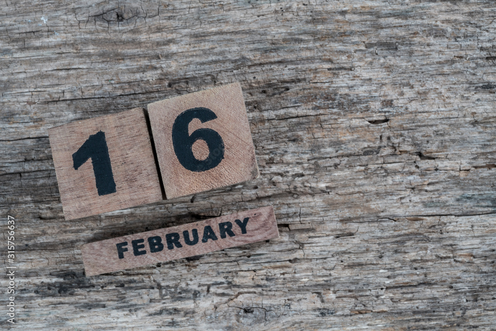 cube calendar for february on wooden background with copy space cube calendar for february on wooden background with copy space