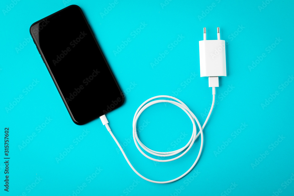 white phone cable on blue background. white phone cable on blue background.